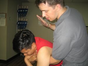 Back Blows for a choking conscious victim in First Aid Training Surrey